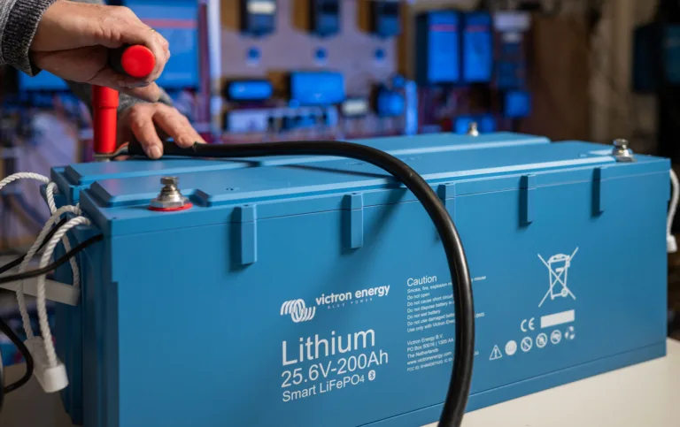 Victron 25.6V 200Ah lithium battery being wired up on the workshop bench