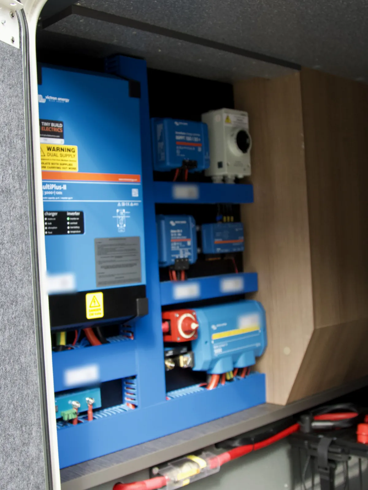 Victron board we fitted in the locker of a Carthago motorhome, with a MultiPlus-II inverter charger, SmartSolar MPPT, Orion XS DC-DC charger, battery switch and Lynx Power In on blue shelves