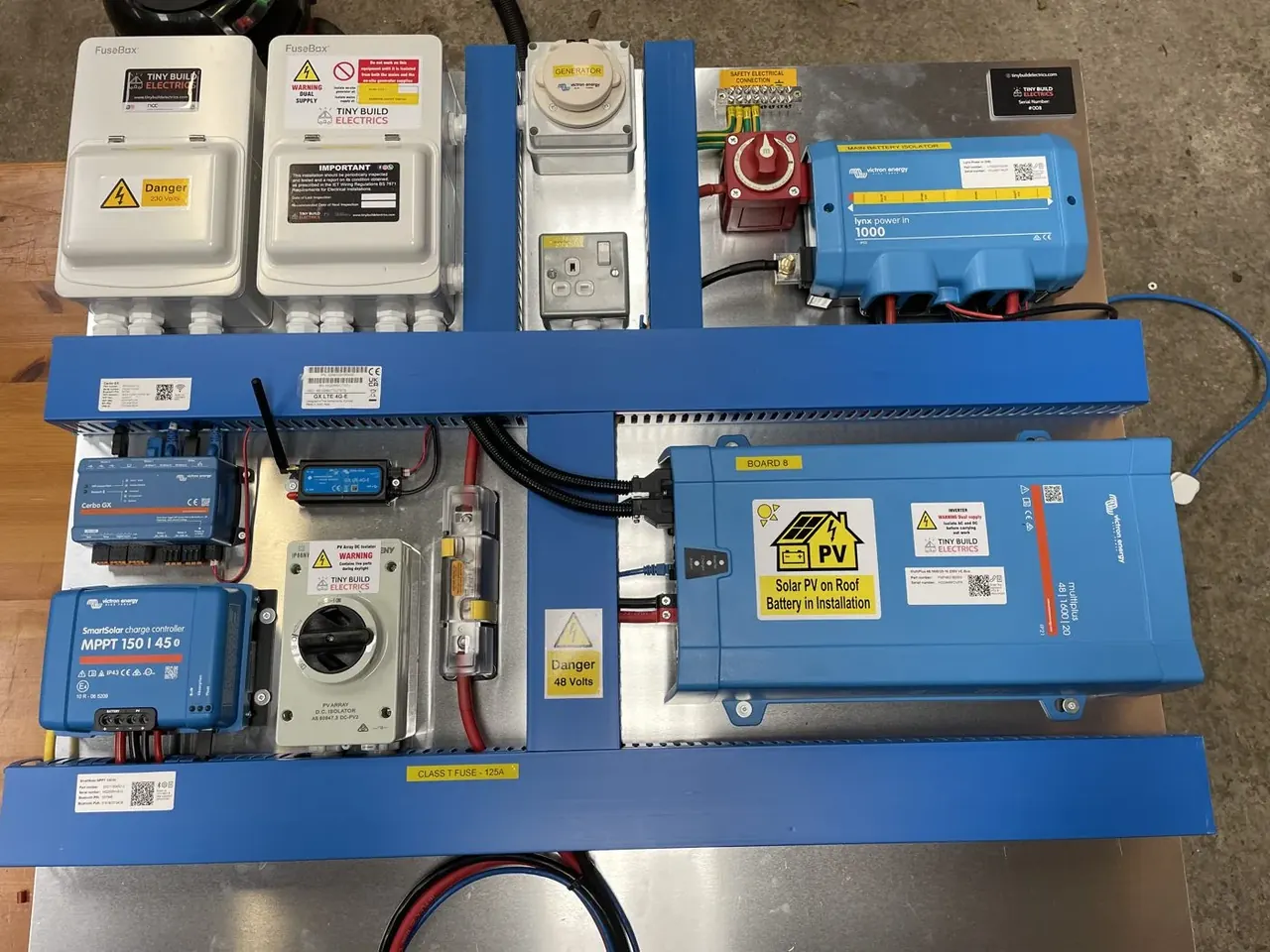 48 volt Victron board on the workshop bench with an inverter charger, solar charge controller and GX monitor