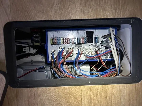 Factory motorhome power unit fuse panel in a floor hatch, typical location of a built-in split charge relay